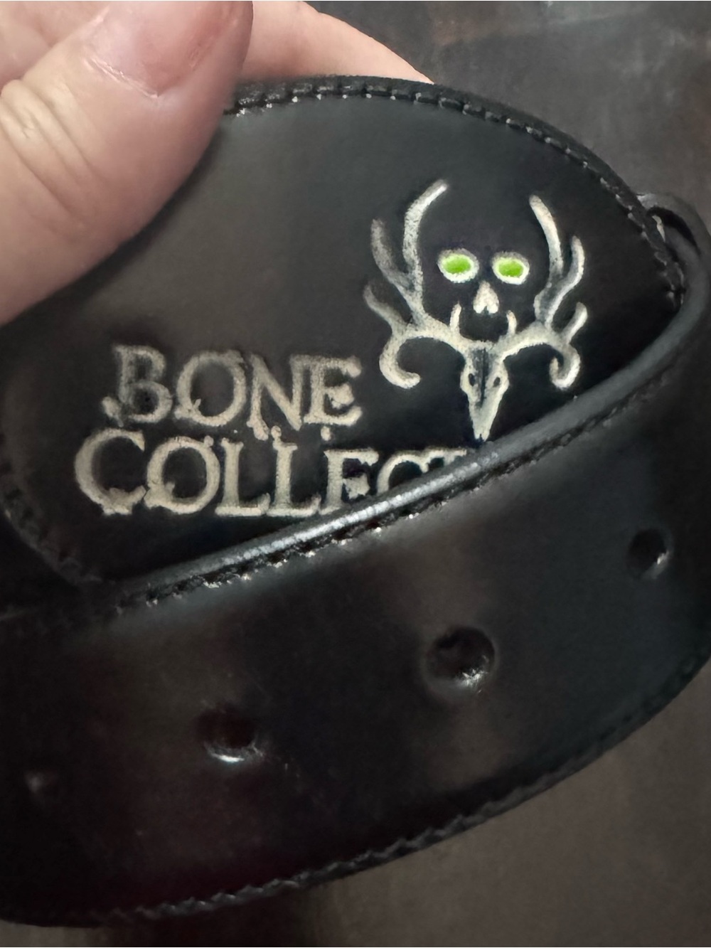 Bone Collector Black Leather Belt with Embroidered Logo and Green Eye Accent